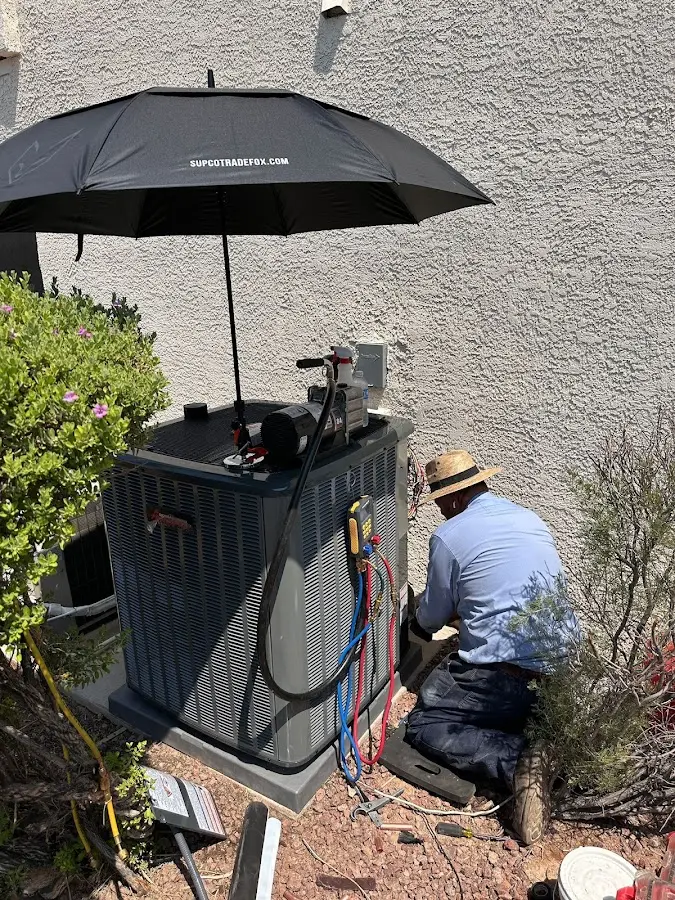 HVAC technician performing outdoor AC maintenance in Burbank